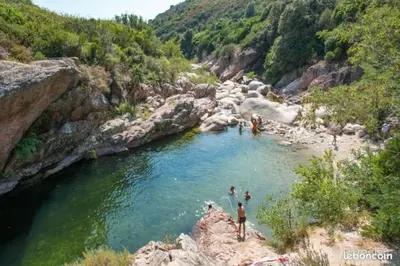 a group of people swimming in a river at Casa de Patarra Villa avec piscine privée dans un havre de paix in Peri