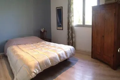 a bedroom with a bed and a window and a dresser at Casa de Patarra Villa avec piscine privée dans un havre de paix in Peri