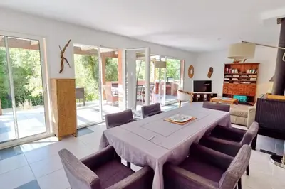 a large living room with a table and chairs at Casa de Patarra Villa avec piscine privée dans un havre de paix in Peri
