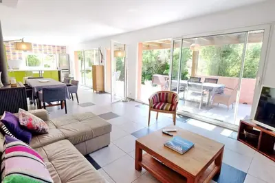 a living room with a couch and a table at Casa de Patarra Villa avec piscine privée dans un havre de paix in Peri
