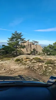 a view from a car windshield of a mountain with trees at studio mezzanine climatisé 40 M2 bord de mer in Lecci