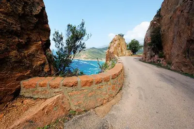 a stone wall on the side of a road at studio mezzanine climatisé 40 M2 bord de mer in Lecci