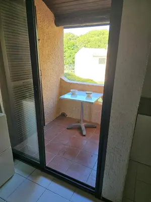 a small table in a room with a window at studio mezzanine climatisé 40 M2 bord de mer in Lecci