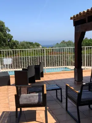 a group of chairs and tables on a patio at Résidence U LATONU in Porto-Vecchio