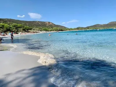 a view of a beach with people in the water at Résidence U LATONU in Porto-Vecchio