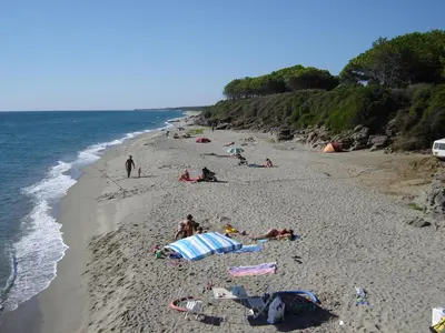 a group of people laying on a beach at Appartamento con 2 camere da letto a 200 m dalla spiaggia in Linguizzetta