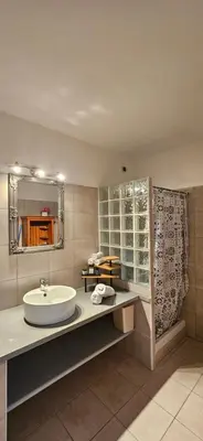 a bathroom with a sink and a mirror at T3 paisible quartier Vigna Maggiore, Olmeto in Olmeto