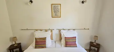 a bedroom with a bed with two pillows on it at T3 paisible quartier Vigna Maggiore, Olmeto in Olmeto