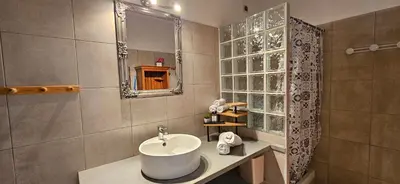 a bathroom with a sink and a mirror at T3 paisible quartier Vigna Maggiore, Olmeto in Olmeto