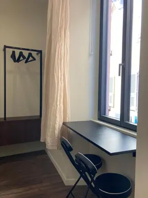a desk and a chair in a room with a window at STUDIO SPACIEUX TOUT CONFORT CITE IMPERIALE in Ajaccio