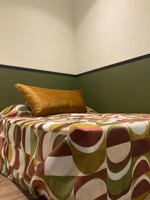 a bedroom with a bed with a pillow on it at STUDIO SPACIEUX TOUT CONFORT CITE IMPERIALE in Ajaccio