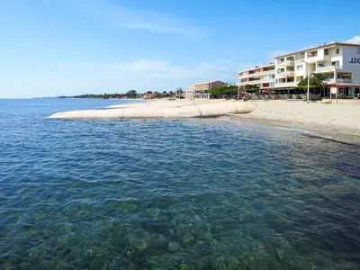 a body of water with a beach and buildings at Apartment MB4 by Interhome in Moriani Plage