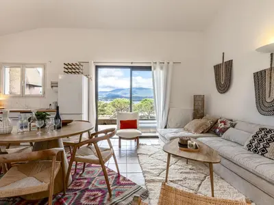 a living room with a couch and a table at Apartment Casetta Bianca by Interhome in Porto-Vecchio