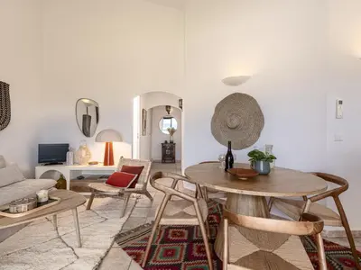 a living room with a table and chairs at Apartment Casetta Bianca by Interhome in Porto-Vecchio