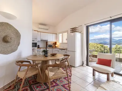 a kitchen and dining room with a table and chairs at Apartment Casetta Bianca by Interhome in Porto-Vecchio