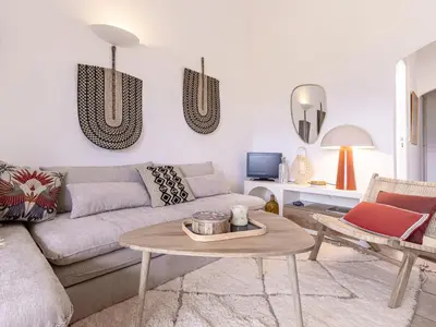 a living room with a couch and a table at Apartment Casetta Bianca by Interhome in Porto-Vecchio