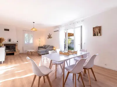 a dining room and living room with a table and chairs at Holiday Home Turriccioli by Interhome in Porto-Vecchio