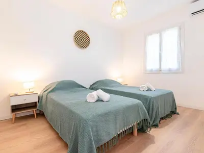 two beds in a white room with green sheets at Holiday Home Turriccioli by Interhome in Porto-Vecchio