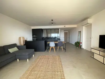 a living room with a couch and a table at Appartement T3 face à la mer in Ajaccio