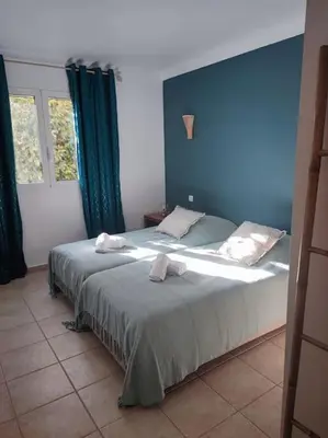 a bedroom with a bed with two towels on it at Appartement & Piscine Santa Giulia in Porto-Vecchio
