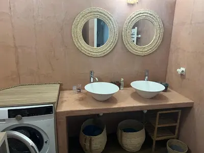 a bathroom with two sinks and two mirrors at Appartement & Piscine Santa Giulia in Porto-Vecchio