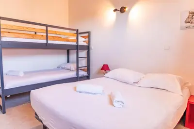 a bedroom with two bunk beds with towels on them at Villa U Meribellu Di Santa Lucia in Sainte-Lucie de Porto-Vecchio