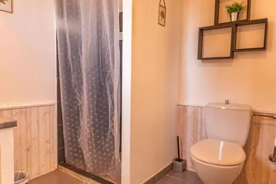 a bathroom with a toilet and a shower curtain at Villa U Meribellu Di Santa Lucia in Sainte-Lucie de Porto-Vecchio