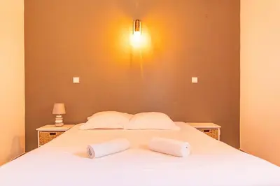 a bedroom with a bed with two pillows on it at Villa U Meribellu Di Santa Lucia in Sainte-Lucie de Porto-Vecchio