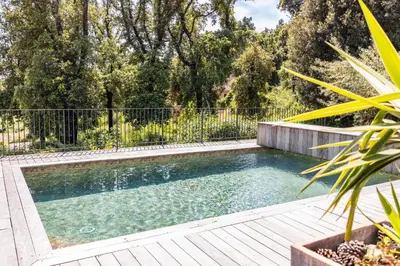 a swimming pool in a yard with a fence at Villa U Meribellu Di Santa Lucia in Sainte-Lucie de Porto-Vecchio