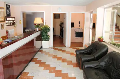 a living room with a counter and leather chairs at Hôtel Sampiero Corso in Corte