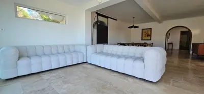 a large white couch sitting in a living room at Villa de standing Les Amandiers, vue mer & piscine in Propriano
