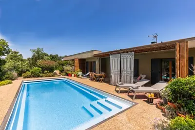 a swimming pool in the backyard of a house at Villa Baccarat in Porto-Vecchio