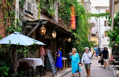 a group of people walking down a street at Villa Baccarat in Porto-Vecchio