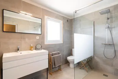 a bathroom with a sink and a shower at Villa Baccarat in Porto-Vecchio