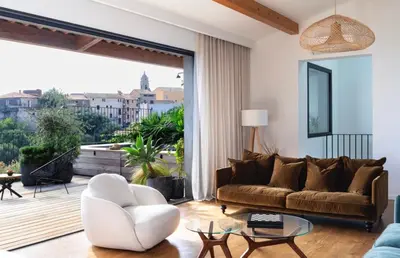 a living room with a couch and a large window at Penthouse Les Oliviers in Porto-Vecchio