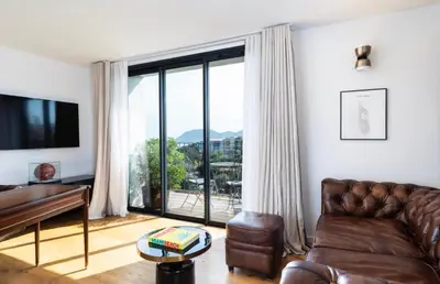 a living room with a couch and a piano at Penthouse Les Oliviers in Porto-Vecchio