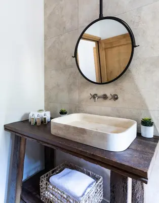 a bathroom with a sink and a mirror at Villa Occhinello in Propriano