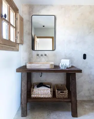 a bathroom with a sink and a mirror at Villa Occhinello in Propriano