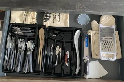 a drawer filled with utensils and other kitchen items at Superb flat with a lovely view of the mountains in Porto-Vecchio