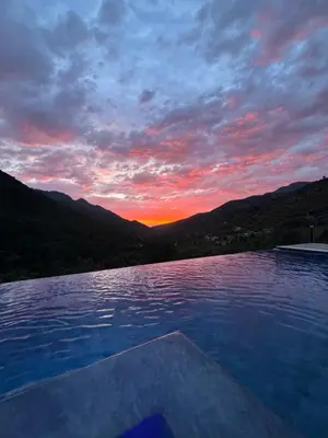 a view of a sunset from a swimming pool at Gîte A Funtana Montestremo, Balagne, Haute Corse in Manso