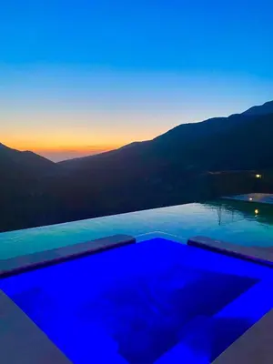 a swimming pool with a view of the mountains at Gîte A Funtana Montestremo, Balagne, Haute Corse in Manso