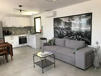 a living room with a couch and a kitchen at Gîte A Funtana Montestremo, Balagne, Haute Corse in Manso