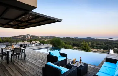 a patio with a table and chairs and a pool at Villa Nepita in Lecci