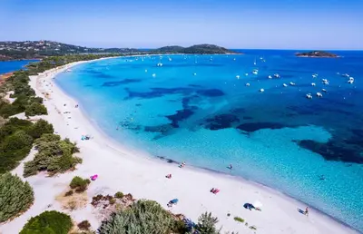 an aerial view of a beach with people in the water at Villa Nepita in Lecci