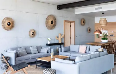 a living room with blue couches and a table at Villa Nuciola in Lecci