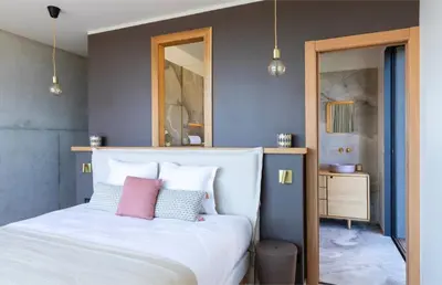 a bedroom with a white bed with pink pillows at Villa Nuciola in Lecci