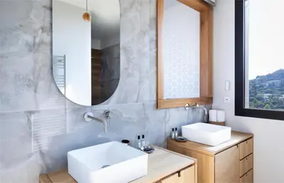 a bathroom with two sinks and a mirror at Villa Nuciola in Lecci