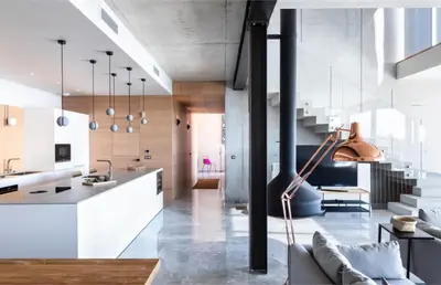 a kitchen and a living room with white cabinets at Villa Nuciola in Lecci