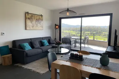 a living room with a couch and a table at Two-bedroom flat with terrace near the harbour and town centre in Porto-Vecchio