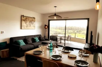 a living room with a table and a couch at Two-bedroom flat with terrace near the harbour and town centre in Porto-Vecchio